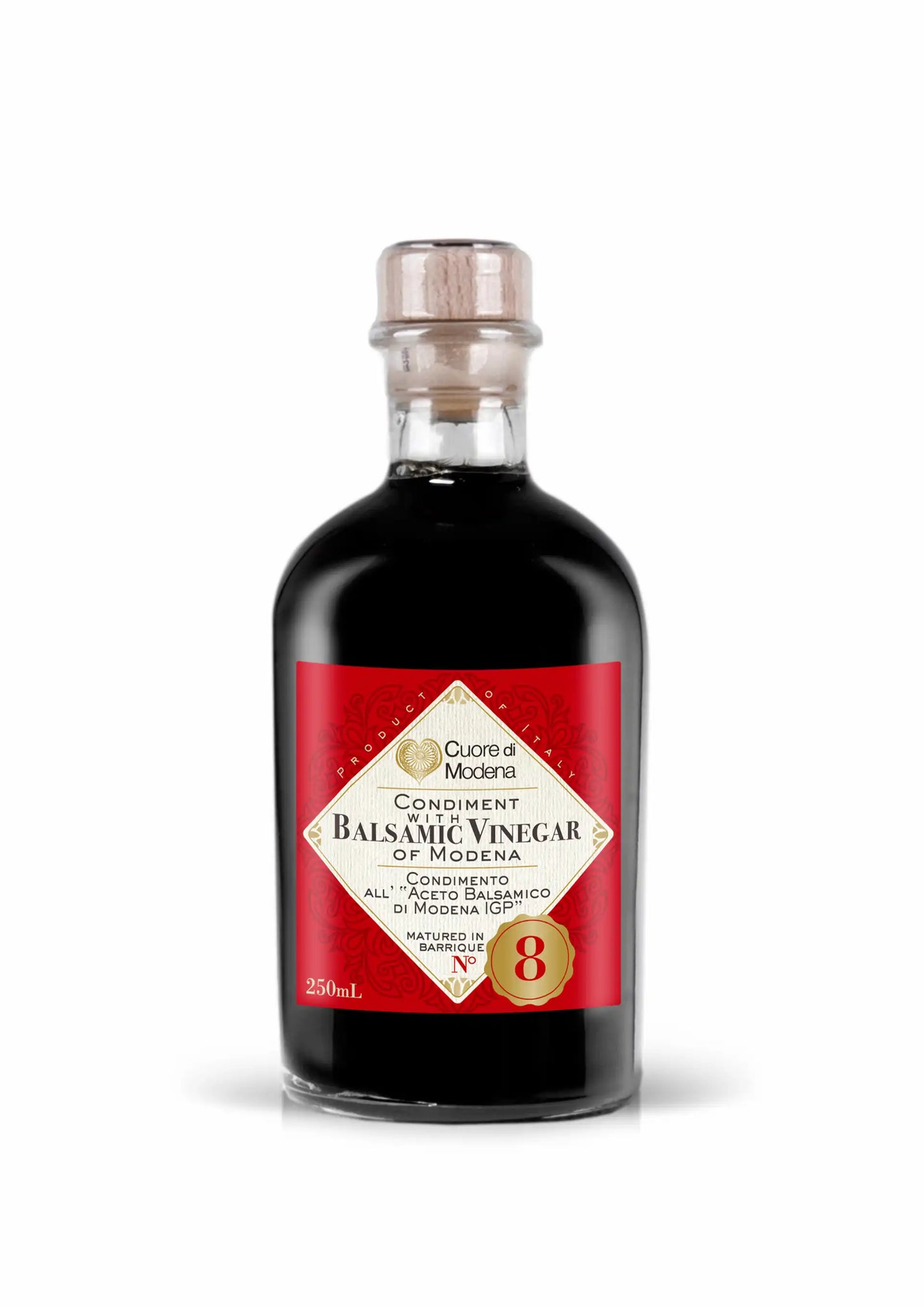 Bottle of balsamic vinegar with a red label on a white background